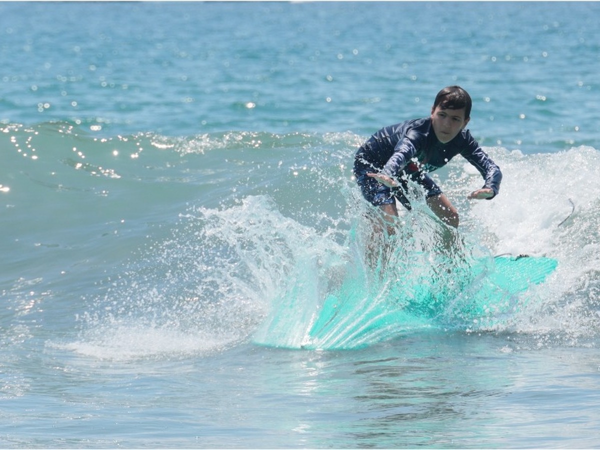 Surfer riding a wave during a lesson in Manuel Antonio