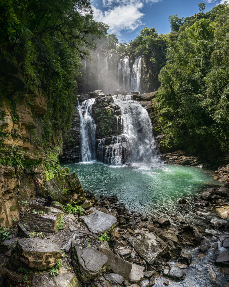 Waterfall cascading into a natural pool in Costa Rica